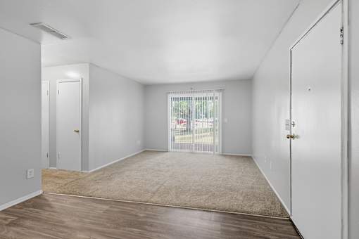 A room with white walls and a wooden floor.