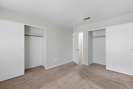 A room with white walls and carpeted floor.