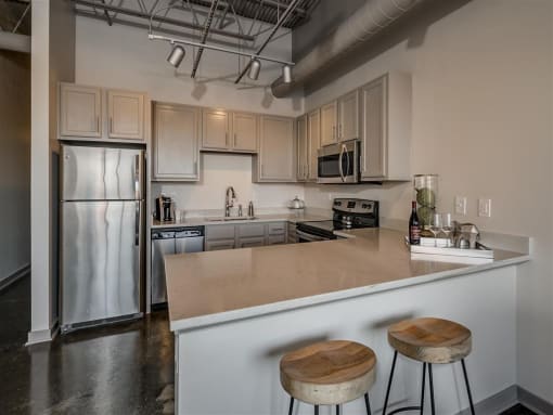 Fitted Kitchen With Island Dining at The Tower Apartments, Alabama, 35401