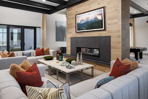 A living room with a fireplace and a painting above it.
