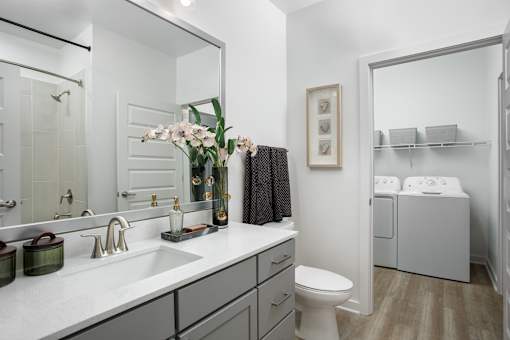 A bathroom with a white toilet and a white sink.