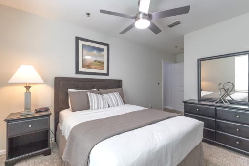 a bedroom with a large bed and a ceiling fan