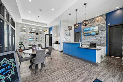 A modern kitchen with a dining table and chairs.