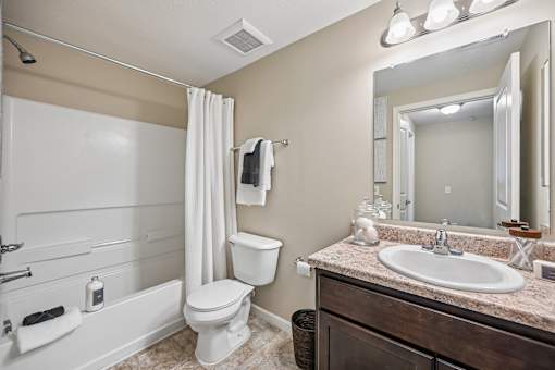 A bathroom with a white toilet and sink.