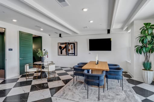 a conference room with a table and chairs and a tv at Tapestry Overbrook in McDonough, Georgia