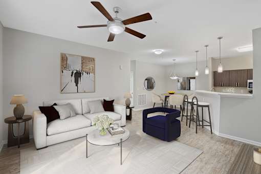 A living room with a white couch and a ceiling fan.