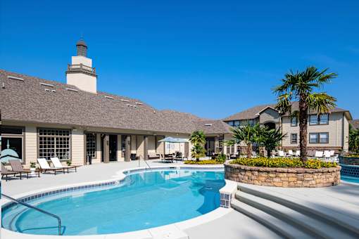 A large house with a pool in front.