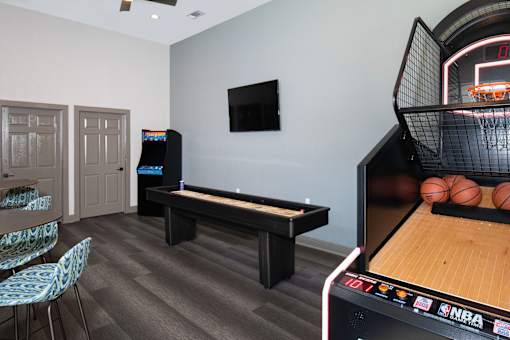 A room with a pool table and a TV.