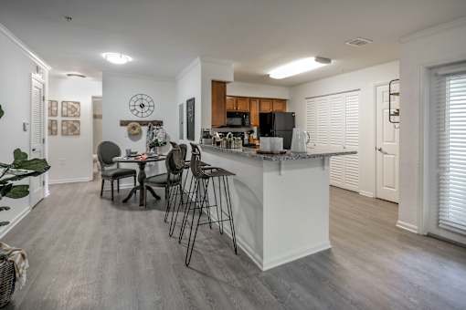 A kitchen with a table and chairs in the middle of the room.