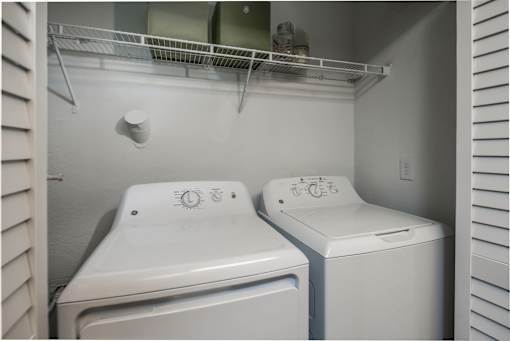 A white toilet and sink in a small bathroom.