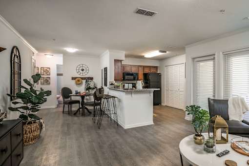 A modern kitchen with a dining table and chairs.