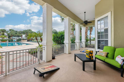 a balcony with a pool and a couch and a coffee table