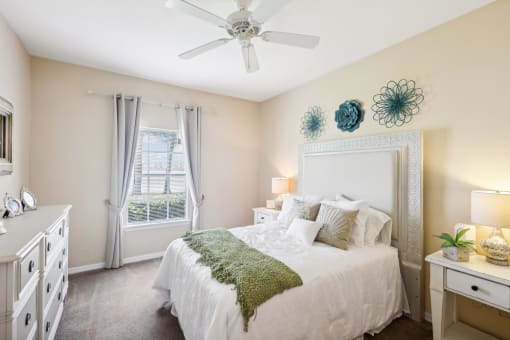 a bedroom with a bed and a ceiling fan