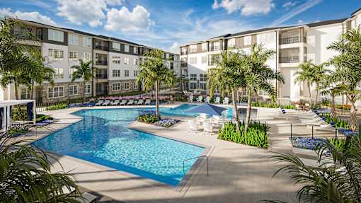 A large swimming pool surrounded by palm trees and lounge chairs.