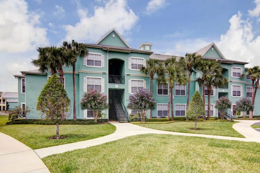Building Exterior and Green Space at Bermuda Estates Apartments in Ormond Beach, FL