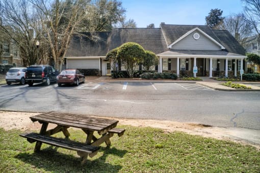 a picnic table in a parking lot in at 10X Audubon Park apartments in Daphne, AL  front of a house