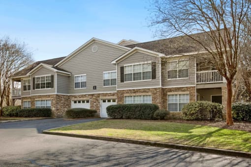 the front of a house with a driveway and lawn at 10X Audubon Park apartments in Daphne, AL 