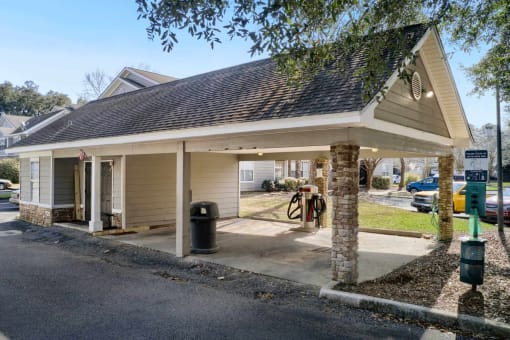 a gas station with a covered parking lot at 10X Audubon Park apartments in Daphne, AL 