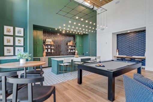 a game room with a pool table and tables