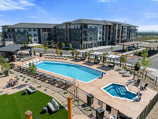 A large building with a pool in front.