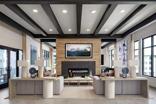 A modern living room with a fireplace and a large painting above it.