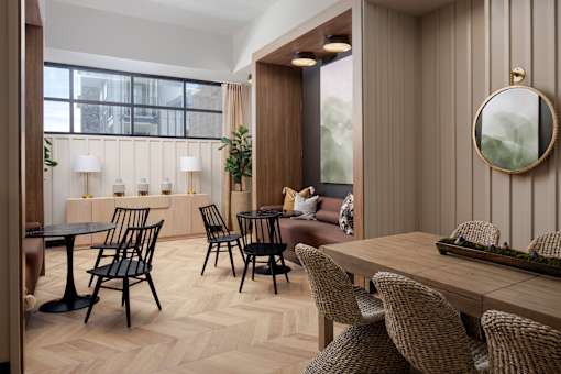 A modern dining room with wooden furniture and a large window.