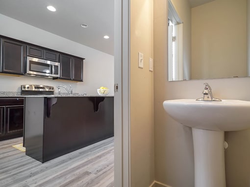 Bathroom with sink and mirror at The Village at Church & Main, Layton, Utah