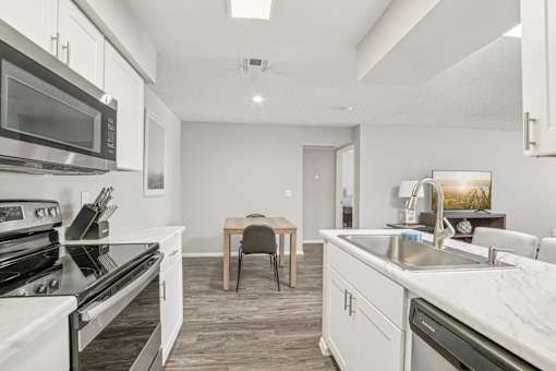 A modern kitchen with a dining table and chairs.