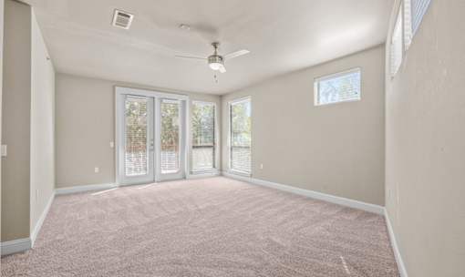 Spacious bedroom with patio doors and carpet at Matilda at Lower Greenville Apartments, Dallas, 75206