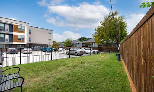 Fenced pet area with grassy lawn at Avion at West Lemmon Apartments, Texas
