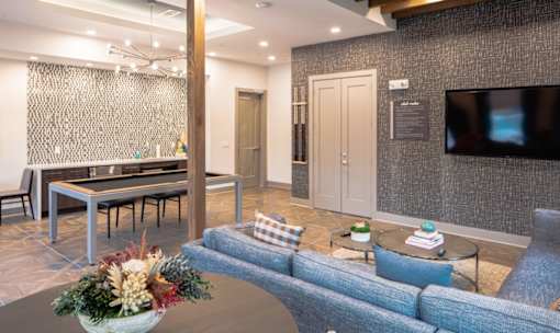 Community clubhouse with lounge and game table at Avion at West Lemmon Apartments, Texas, 75235