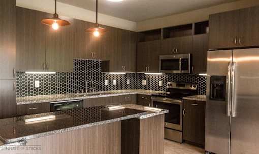 Modern kitchen with pendant lighting and hexagonal backsplash at Matilda at Lower Greenville Apartments, Dallas, 75206