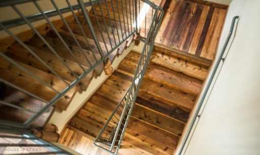 Wooden staircase with metal railing and landing at Matilda at Lower Greenville Apartments, Dallas