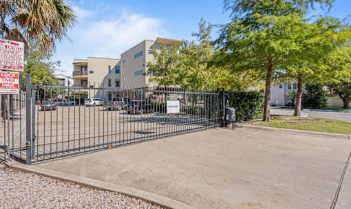 Gated parking lot entrance with security access at Matilda at Lower Greenville Apartments, Texas