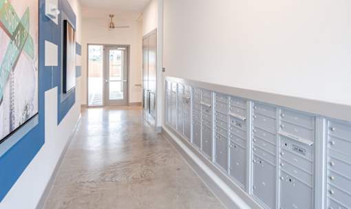 Mailroom hallway with resident mailboxes at Avion at West Lemmon Apartments, Dallas, Texas