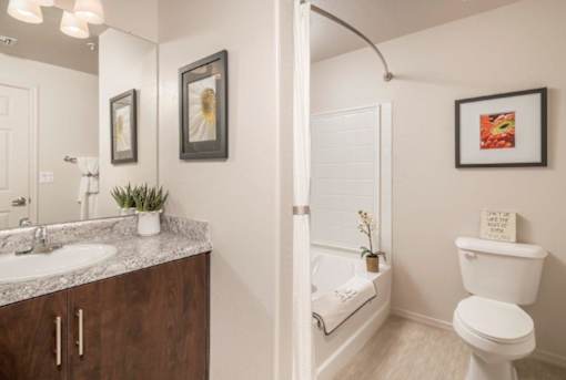 A bathroom with a white toilet and a white sink.