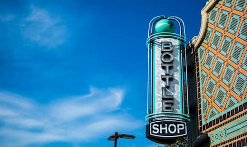Vintage bottle shop neon sign in urban setting at Matilda at Lower Greenville Apartments, Dallas, 75206
