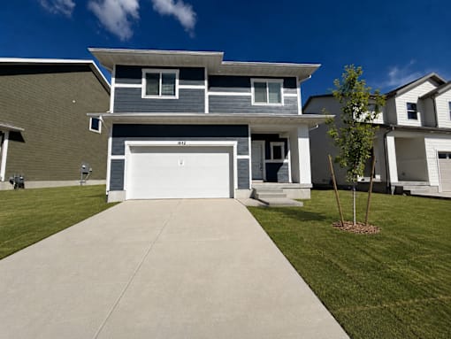 A modern house with a grey garage door.