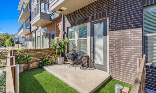 Private patio with artificial turf and seating at Avion at West Lemmon Apartments, Dallas