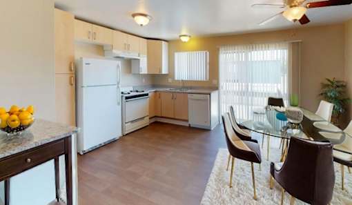 a kitchen and dining room with a table and chairs