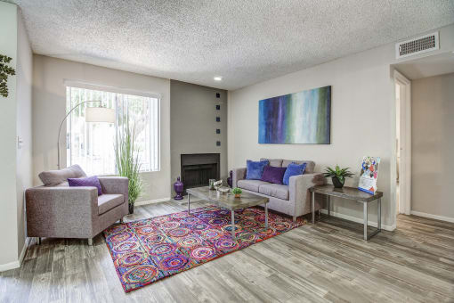 a living room with couches and chairs and a rug
