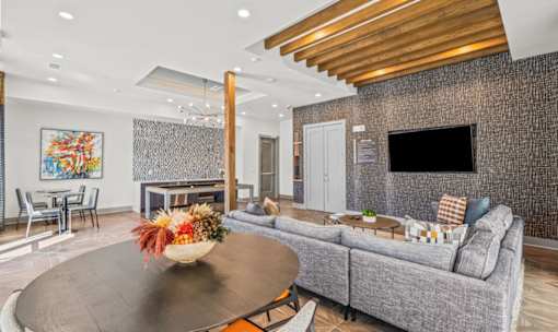 Open living room with wood beam ceiling accents at Avion at West Lemmon Apartments, Dallas, TX 75235