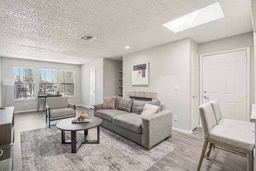 A living room with a grey couch and a coffee table.