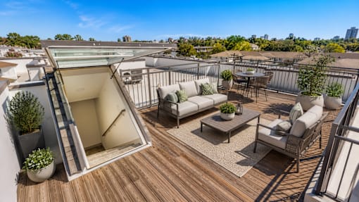 Rooftop terrace with seating and dining areas at Avion at West Lemmon Apartments, Dallas, TX