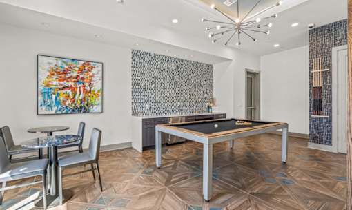 Game room with pool table and seating at Avion at West Lemmon Apartments, Dallas, 75235