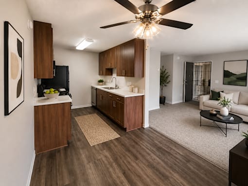 A modern kitchen with wooden cabinets and a ceiling fan.