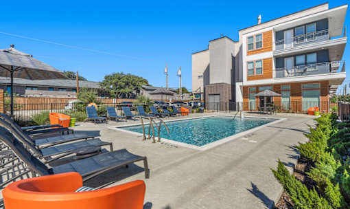 Resort style pool with lounge chairs and sundeck at Avion at West Lemmon Apartments, Dallas, Texas