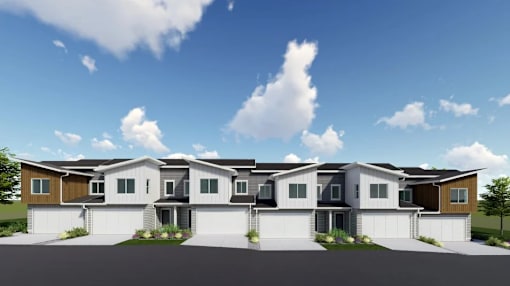 A row of houses with garages in front.
