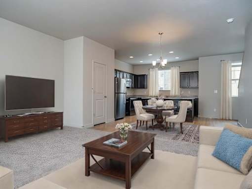Living room with TV at The Village at Church & Main, Layton, UT