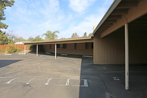 A parking lot with a building in the background.